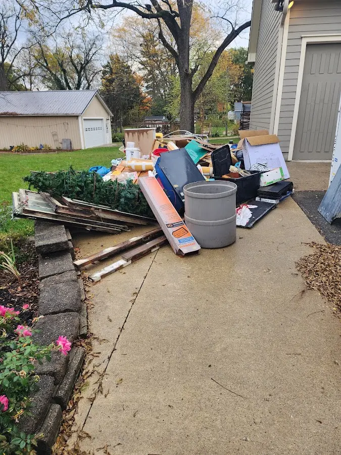 Dumpster being loaded with debris for 12 Yard Dumpster Rental in Mayville